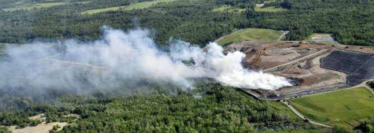 A huge, smoky fire burns as wind blows smoke for miles Tuesday from Waste Management Crossroads Landfill in Norridgewock.