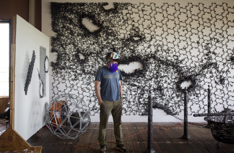 John Bisbee poses for a portrait at his studio in the Fort Andross Mill in Brunswick. Bisbee's "American Steel" opened Saturday at the Center for Maine Contemporary Art in Rockland.