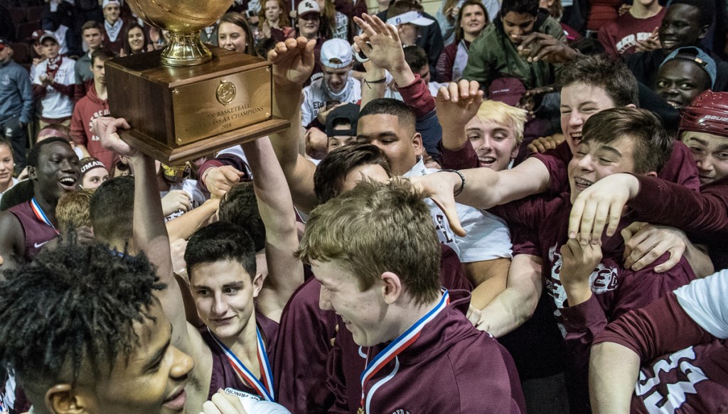 Edward Little point guard Tyler Morin hoisted the Gold Ball as the Red Eddies celebrated their win over Scarborough for the Class AA basketball championship.