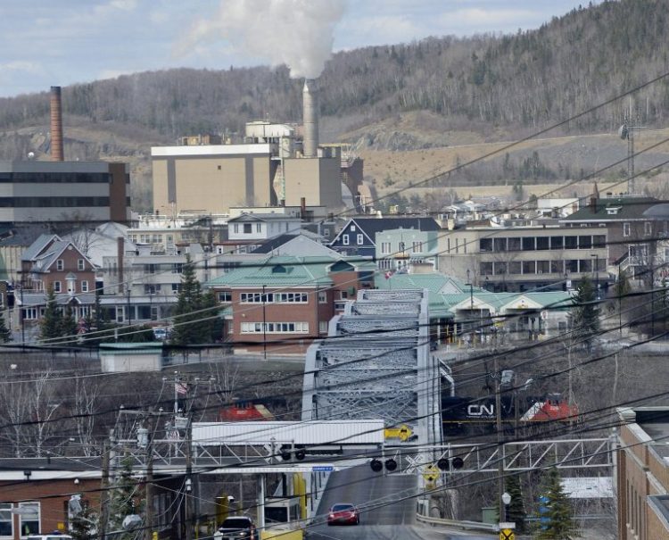 MADAWASKA, ME - MAY 8: Paper Mill workers file out onto Bridge Ave. after their shift Thursday, May 8, 2014.  Edmundston, Canada can be seen across the bridge.(Photo by Shawn Patrick Ouellette/Staff Photographer)