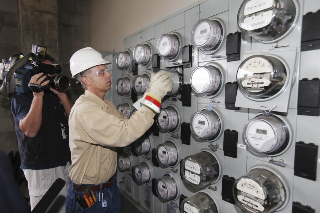 A Central Maine Power technician works in Portland in 2010. The power company is the focus of a billing probe.