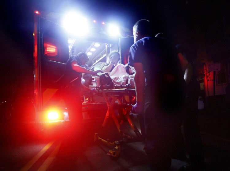 Portland paramedics respond to a call of a heroin overdose on Congress Street near the intersection of India Street. The 29-year-old woman was found unconscious by a passer-by after she had injected herself with a quarter-gram of heroin. 