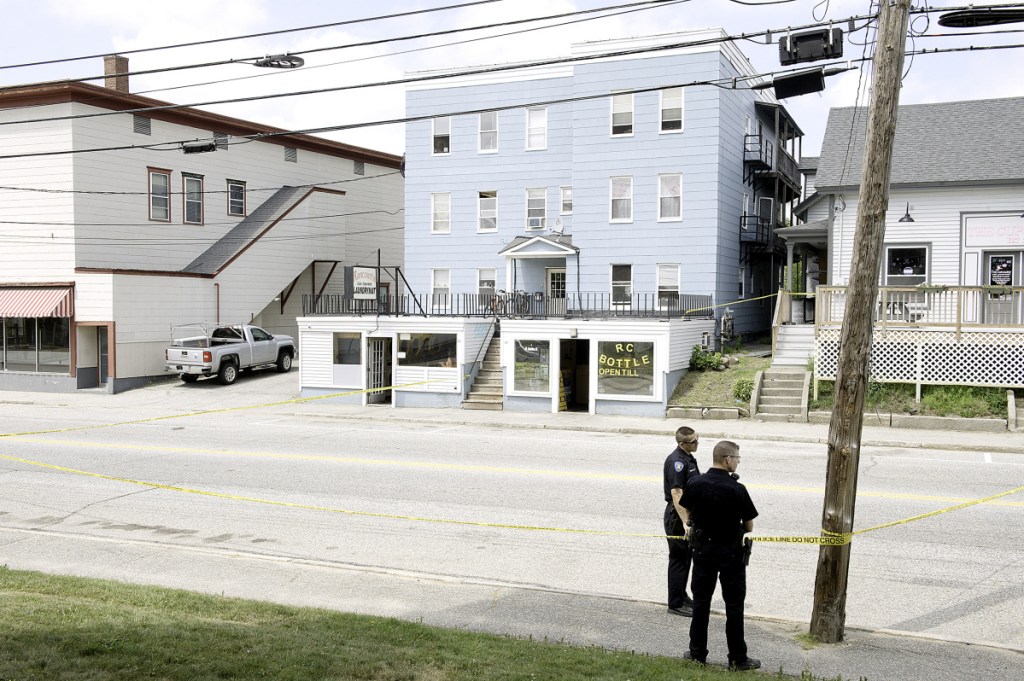 Lewiston police officers Sunday morning closed Sabattus Street, between Oak and College streets, while investigating a stabbing outside Rancourt's Laundromat.  (Daryn Slover/Sun Journal)