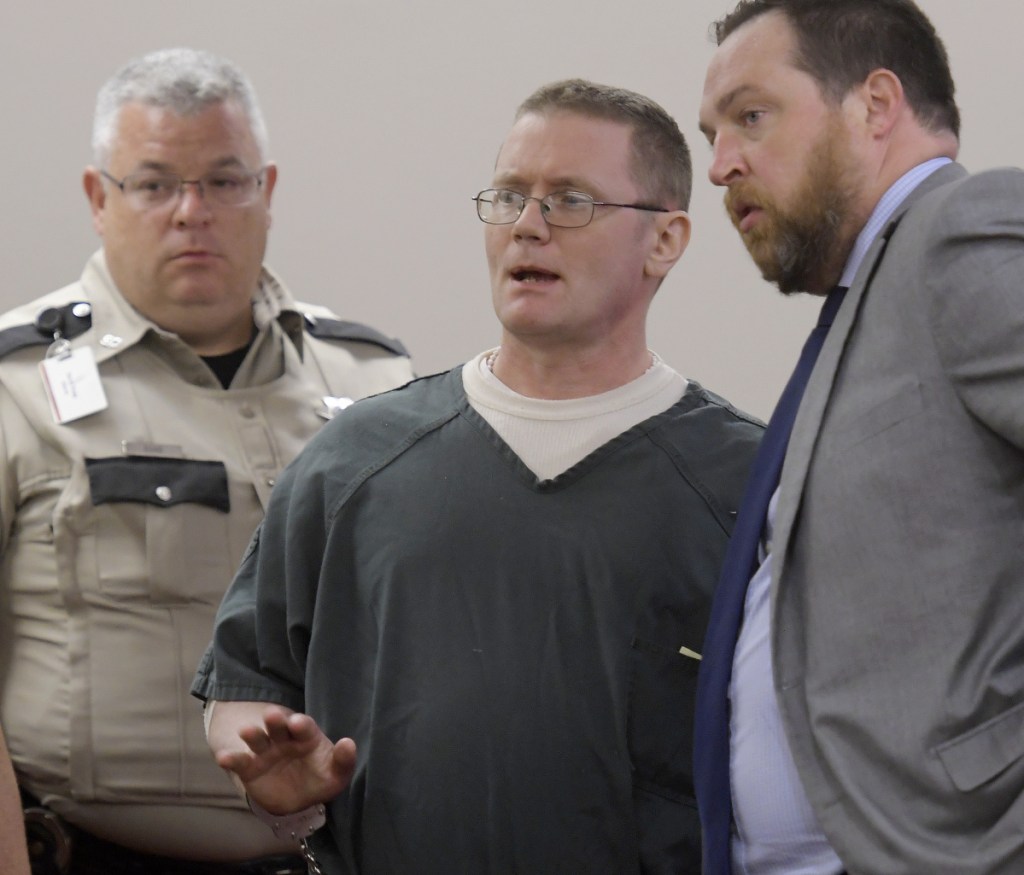 Michael Sean McQuade confers Monday with his attorney, Andrew Wright, during his sentencing. He was ordered to serve 12 years in prison with 13 years suspended and four years of probation.