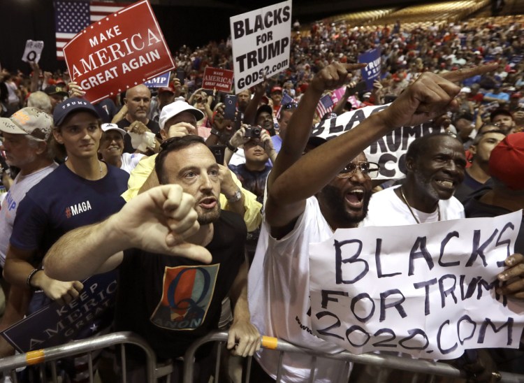 Supporters of President Trump shout down a CNN news crew in July before a rally in Tampa, Fla. 