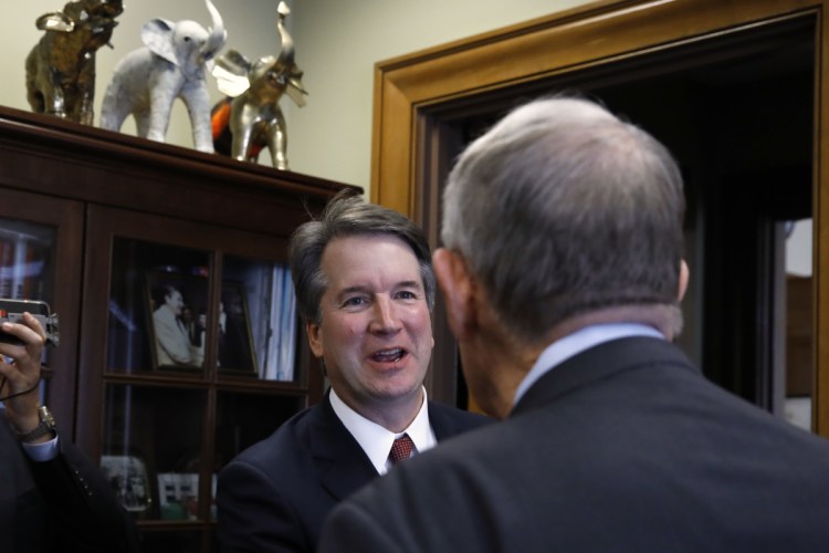 Supreme Court nominee Judge Brett Kavanaugh, left, shakes hands with Sen. Lamar Alexander, R-Tenn., on July 26 in Washington.