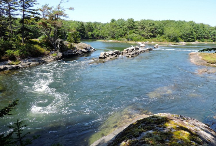 An old granite dam in Phippsburg separates the Morse River on the left and Spirit Pond on the right.