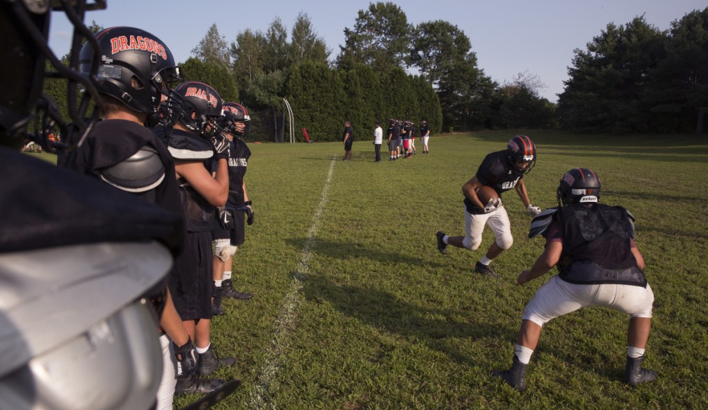 Brunswick junior Treyvon McKenzie, second from right, runs with the ball as the Dragons go through a tackling drill during preseason practice. Brunswick, just two years removed from a state championship season, brings a renewed focus this year after going 2-8 in 2017.