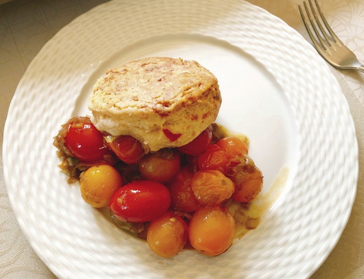 The writer wanted the cobbler to be simple and showcase the fresh vine-ripened local tomatoes, so she stuck to essentially two ingredients: leeks and tomatoes.