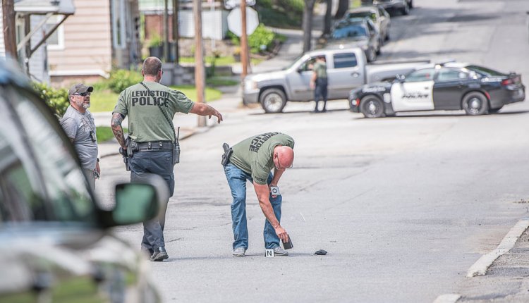 Lewiston police pick up evidence found on Bradley Street after a shooting was reported Thursday afternoon. 