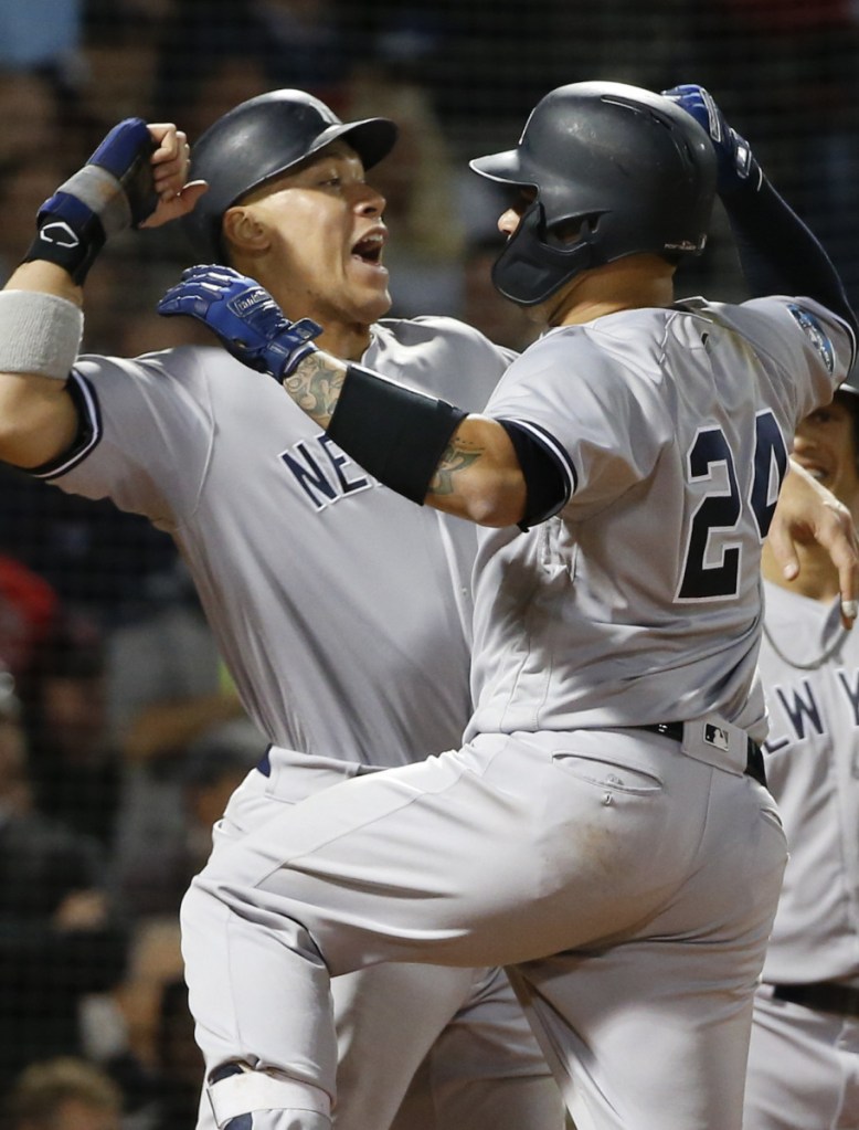 Gary Sanchez, right, celebrates with Aaron Judge after Sanchez's three-run home run in the seventh inning Saturday night at Fenway Park in Boston.