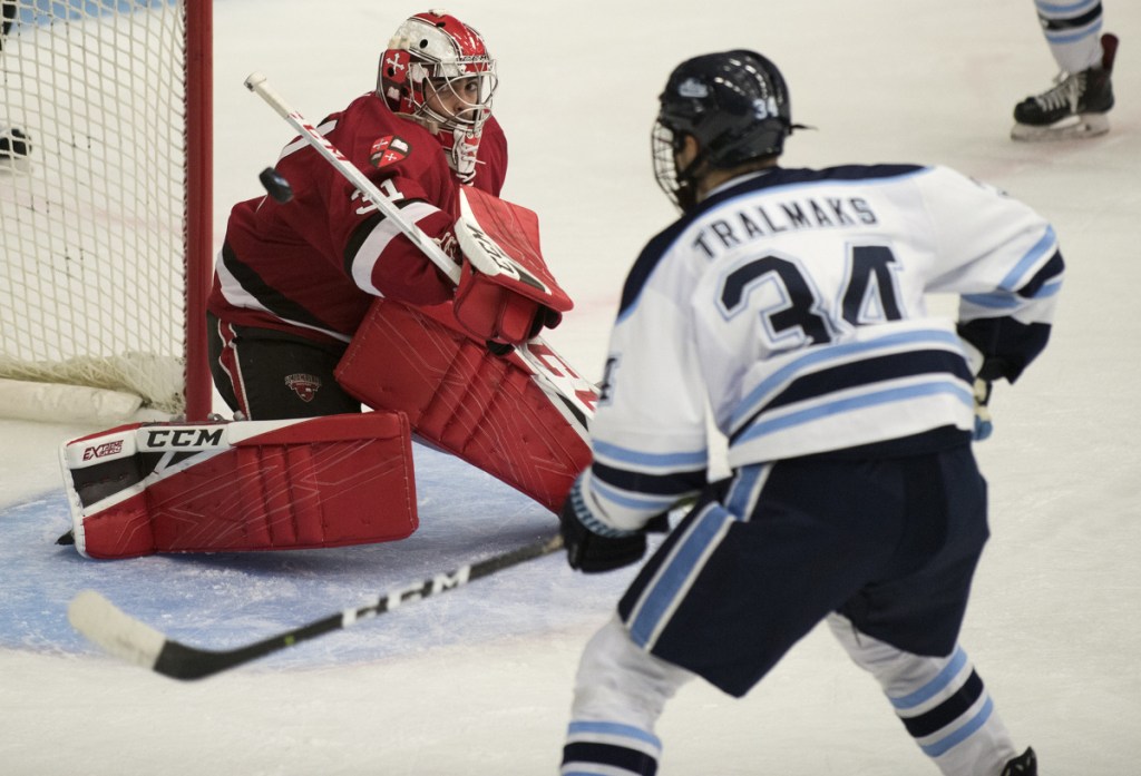 St. Lawrence's Arthur Brey watches the puck fly past him as Maine's Eduards Tralmaks looks for the rebound at Alfond Arena in Orono on Friday.