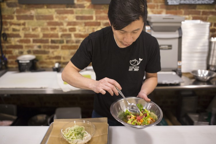 Anusat Limsitong, who also operates Thai 9 in Scarborough, opened his new restaurant in July. Here he prepares a chirashi poké bowl.