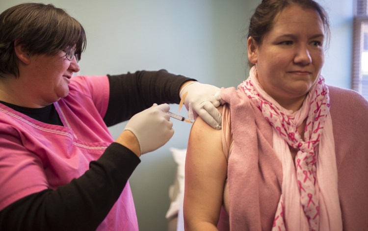 Medical Assistant Cathy Phadden gives co-worker and Registered Nurse Leah Young the "Tdap" vaccine at Nasson Health Care in Springvale on Friday. The vaccine inoculates for diphtheria, tetanus and pertussis.