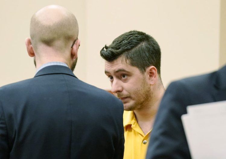 Joseph Lewis, 27, charged with felony aggravated assault, stands with attorney Stephen Shea during his initial court appearance Wednesday in Portland.