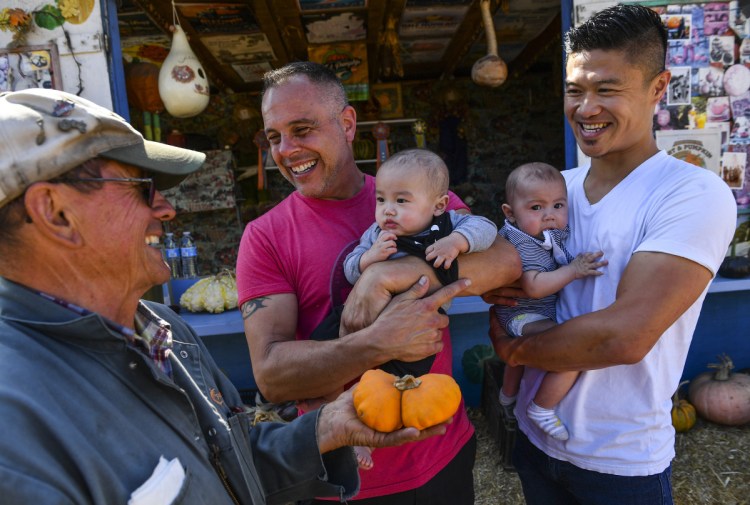 Pumpkin grower John Muller chats with customers at Daylight Farms in Half Moon Bay, California. Muller, 72, hopes to use part of his 21-acre farm to grow young marijuana plants and use the profits to keep the farm operating.