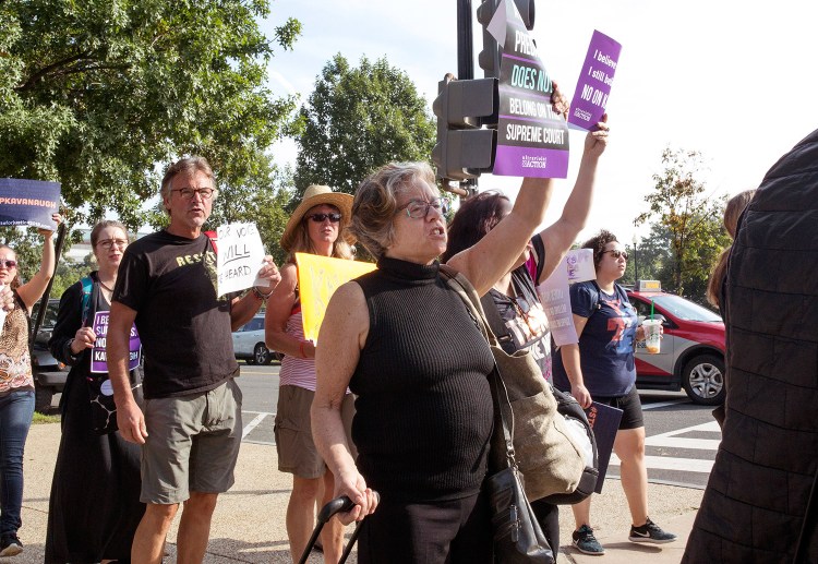 Susan Feiner holds up a no on Kavanaugh sign while walking to the Senate office building in Washington, D.C., with a group of Mainers on Oct. 4. The group traveled from Maine in hopes of meeting with Sen. Susan Collins about Supreme Court nominee Brett Kavanaugh. Feiner, a retired USM professor, was later barred from teaching at the college because she offered students a “pop-up” course for credit to take the bus to Washington with the demonstrators. 