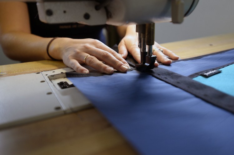 A worker stitches a bag at the Flowfold facility in Scarborough in 2016. The move to a larger space in Gorham will allow the company to bring most of its manufacturing in-house.