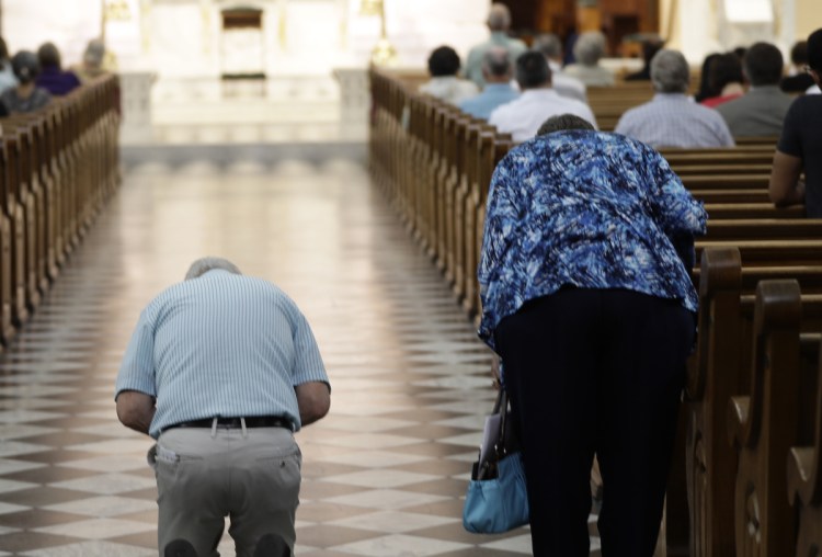 Parishioners arrive for Mass at the Cathedral Church of St. Patrick in Harrisburg, Pa. The church is struggling with an array of issues, including declining attendance at church.