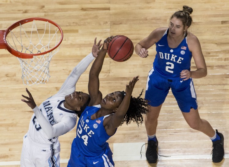 Tanesha Sutton, left, fights for a rebound with Duke's Onome Akinbode-James as Haley Gorecki looks on during Duke's 66-63 win Thursday night at Cross Insurance Center in Bangor.