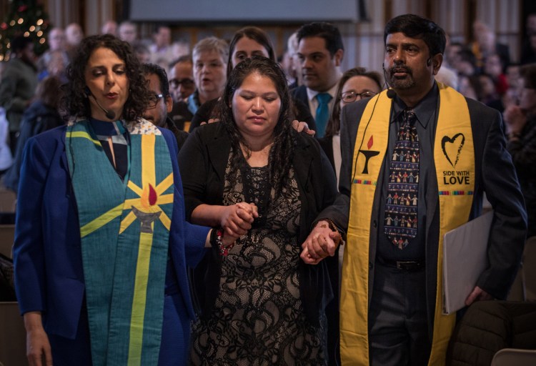 Rosa Gutierrez Lopez, center, leaves a news conference at Cedar Lane Unitarian Universalist Church in Bethesda, Md., on Wednesday.