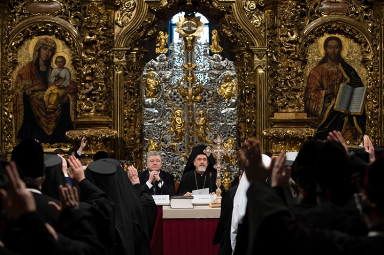 Ukrainian President Petro Poroshenko, center left, attends a closed-door synod of three Ukrainian Orthodox churches to approve the charter for a unified church and to elect leadership in the St. Sophia Cathedral in Kiev on Saturday.