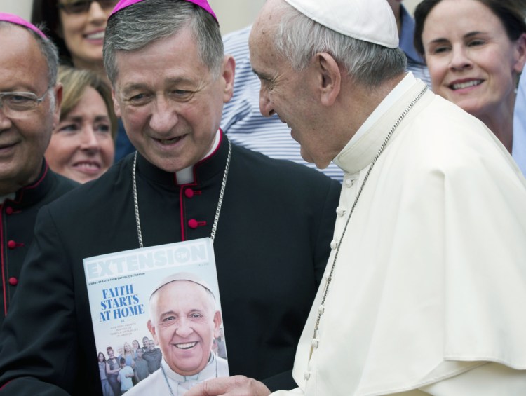 Pope Francis talks with Chicago Archbishop Blase Cupich at the end of his weekly general audience in St. Peter's Square in 2015.