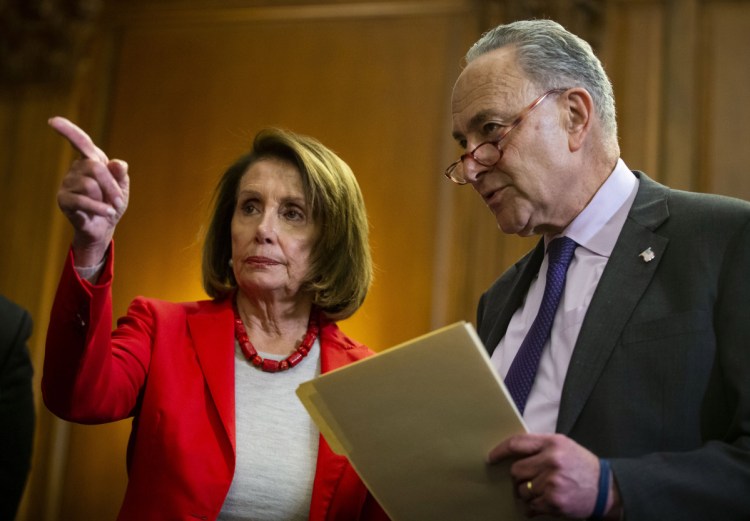 House Speaker Nancy Pelosi, D-Calif., speaks with Senate Minority Leader Chuck Schumer, D-N.Y., on Capitol Hill on Wednesday. A day after Pelosi wrote to President Trump asking him to cancel his State of the Union address because of the government shutdown, he postponed an unannounced trip she had planned abroad, beginning in Afghanistan, calling it an "excursion" and "public-relations event."