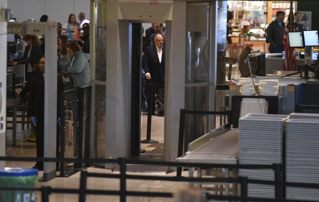 Maryland Gov. Larry Hogan, center, is escorted around the security-screening area on a tour of Baltimore-Washington International Marshall Airport on Thursday, the 34th day of the shutdown. MUST CREDIT: Washington Post photo by Ricky Carioti