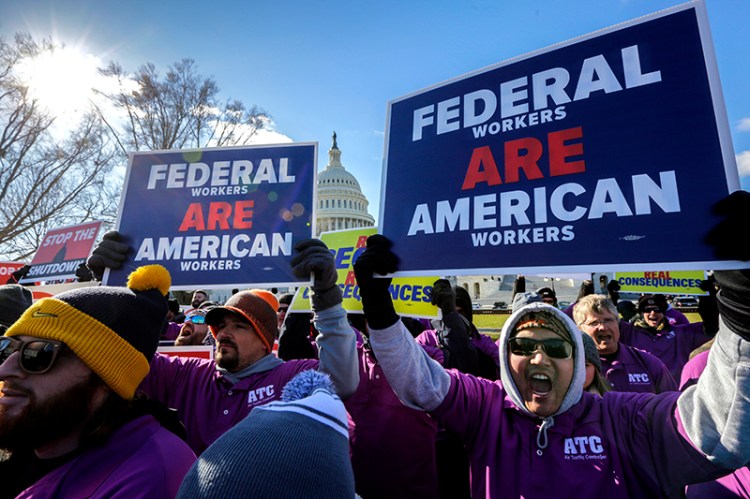 On the 20th day of a partial government shutdown, federal employees rally at the Capitol to protest the impasse between Congress and President Donald Trump over his demand to fund a U.S.-Mexico border wall, in Washington, Thursday, Jan. 10, 2019. (AP Photo/J. Scott Applewhite)