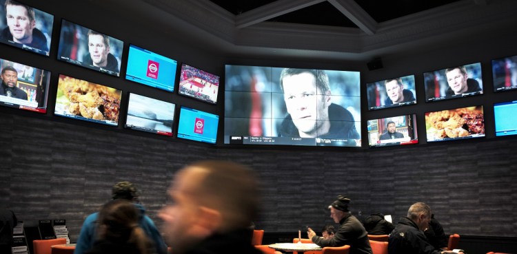 Patrons visit the sports-betting area of Twin River Casino in Rhode Island. The issue is the focus of a series of Maine bills this session.