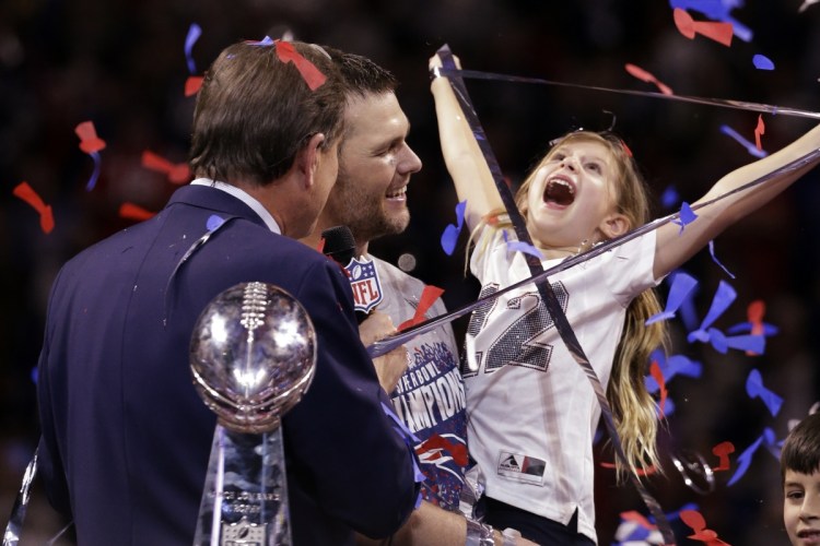 Tom Brady holds his daughter, Vivian, after Super Bowl 53.