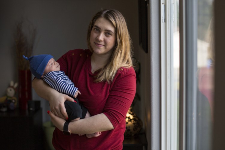 Amber Gorrow holds her son Leon, 8 weeks, at their home in Vancouver, Washington.  Gorrow is staying home with her son as much as possible until he is old enough to get the vaccine. 
