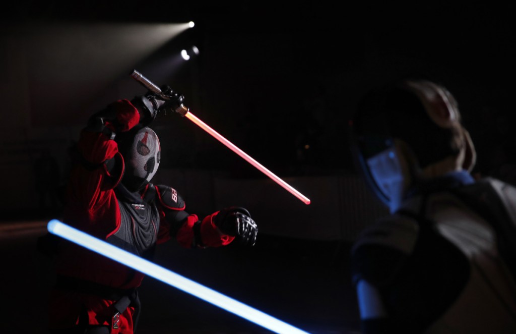Julien Esprit, left, competes with Jean Baptiste Marchetti-Waternaux during a lightsaber tournament in France. The fencing federation has officially recognized lightsaber dueling as a competitive sport.