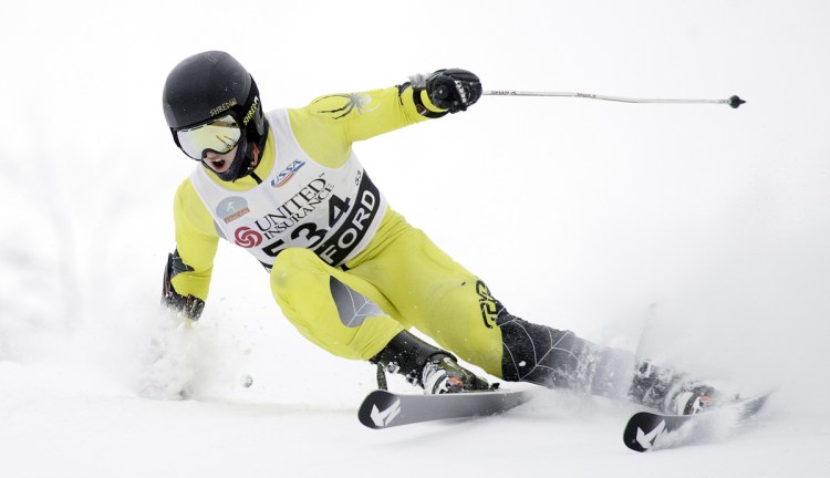 Devon Lathrop of Cape Elizabeth charges down the giant slalom course in his second run Thursday at Black Mountain to capture his third individual state title and lead his team to the Class B Alpine title.