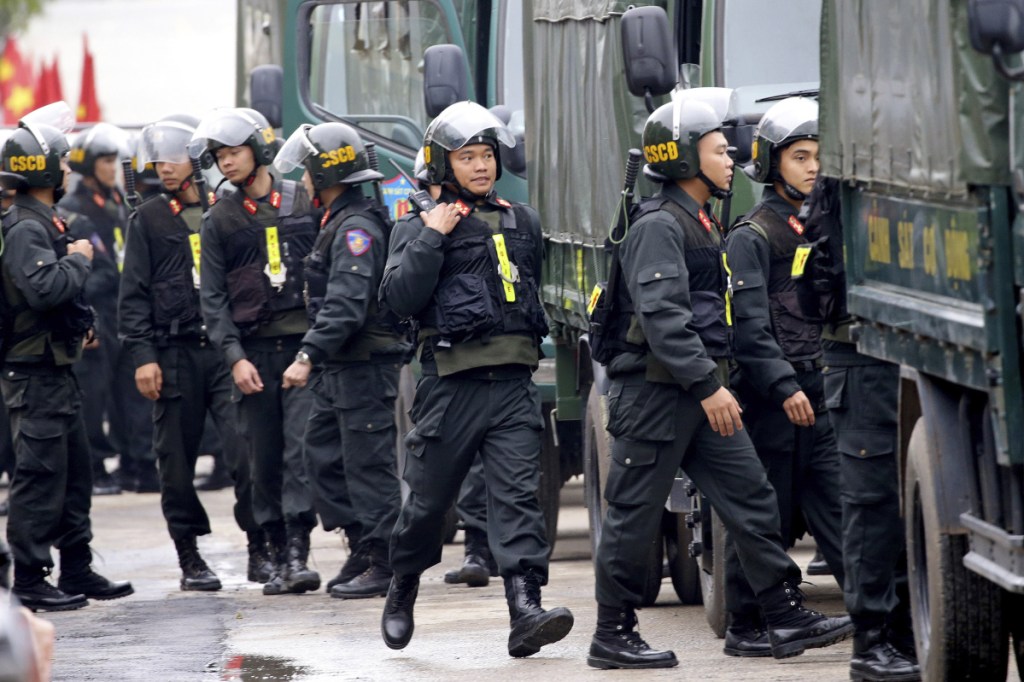 Security guards stand outside the entrance to the train station in Dong Dang, Vietnam, on Monday. North Korean leader Kim Jong Un was expected to arrive at the border town with China on Monday. With Kim on an armored train traveling through China toward Vietnam, and President Trump heading for Hanoi on Air Force One, Vietnamese officials scrambled to finish preparations for a summit that will capture global attention.