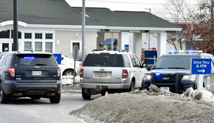 Three police vehicles block the entrance to the Bangor Savings Bank on Waterville Commons Drive in Waterville after a robbery on Tuesday morning.