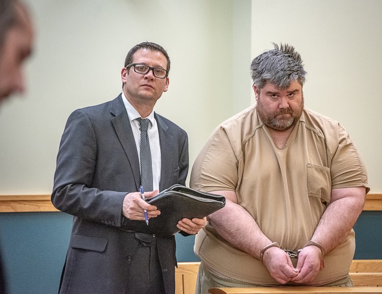 Steven Downs, 44, of Auburn, right, stands for his initial appearance in 8th District Court in Lewiston on Feb. 19. Downs has been charged with the 1993 rape and murder of 20-year-old Sophie Sergie at the University of Alaska Fairbanks. Standing with Downs is attorney Richard Charest.