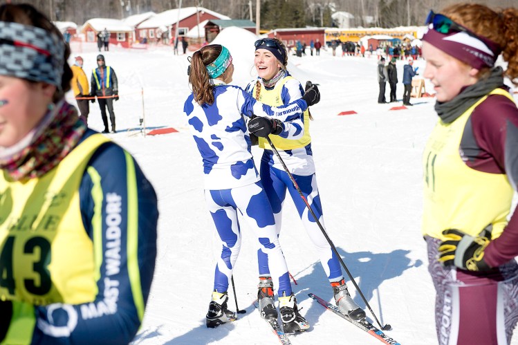 Isabel Brennan, center right, and her Yarmouth  teammate Madeline Marston celebrate after Yarmouth won the Class B state ski championship at Titcomb Mountain in Farmington on Tuesday. 