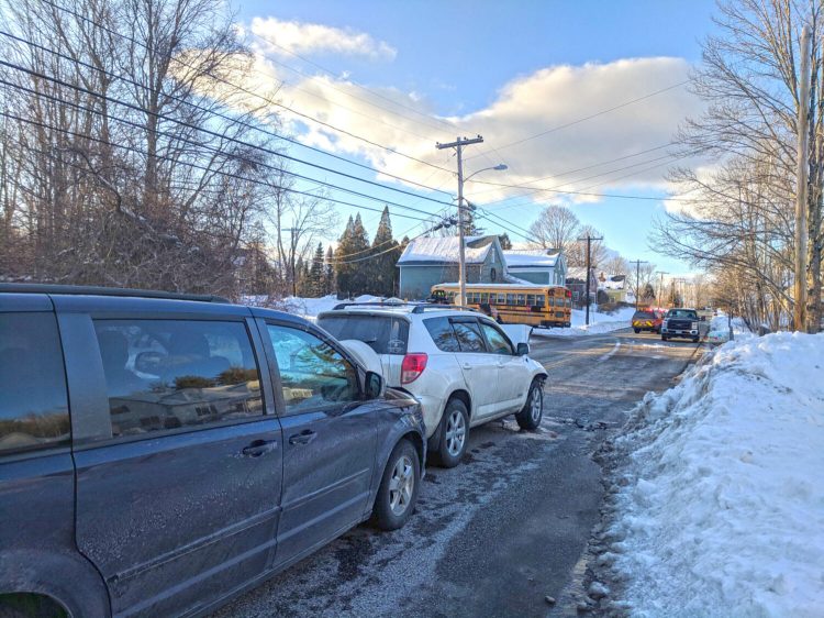 Police say the driver of this white Toyota SUV backed into this Regional School Unit 73 minivan after hitting the Auburn school bus, in background, on West Auburn Road in Auburn on Thursday afternoon. 