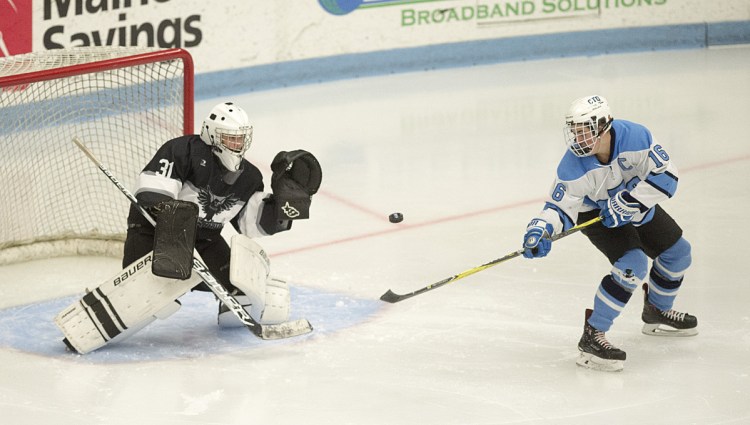 Waterville/Winslow goalie Ben Grenier prepares to make a save on a shot from Old Town/Orono's Sam Henderson during the Class B North final Wednesday at Orono. Old Town/Orono won, 1-0.