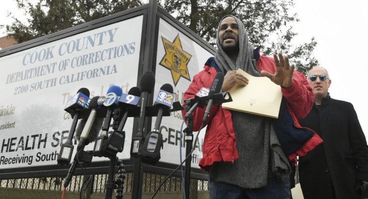 Singer R. Kelly left, speaks to the media with his attorney, Steve Greenberg, after being released from the Cook County Jail on Saturday in Chicago. Kelly was freed after someone paid $161,000 that he owed in back child support.