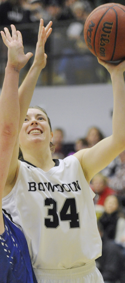 BRUNSWICK, ME -DECEMBER 2: Bowdoin College vs. Colby College women basketball game. Bangor native Cordelia Stewart scores on a short shot over Colby's #30, Emily Davis. (Photo by John Ewing/Staff Photographer)