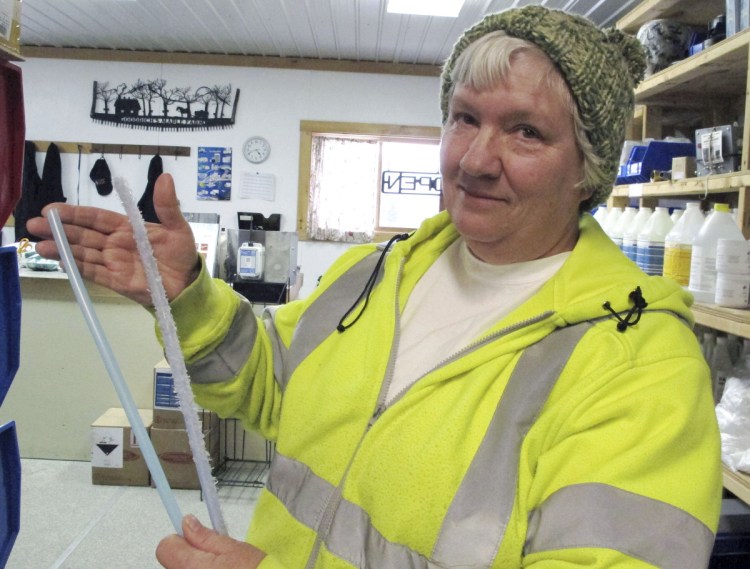 Ruth Goodrich of Goodrich's Maple Farm in Danville, Vt., holds squirrel-damaged maple sap tubing, right, and new tubing, left, in the farm's equipment shop. An abundant squirrel population is wreaking havoc on some maple operations in the Northeast as the season gets off to a late start.