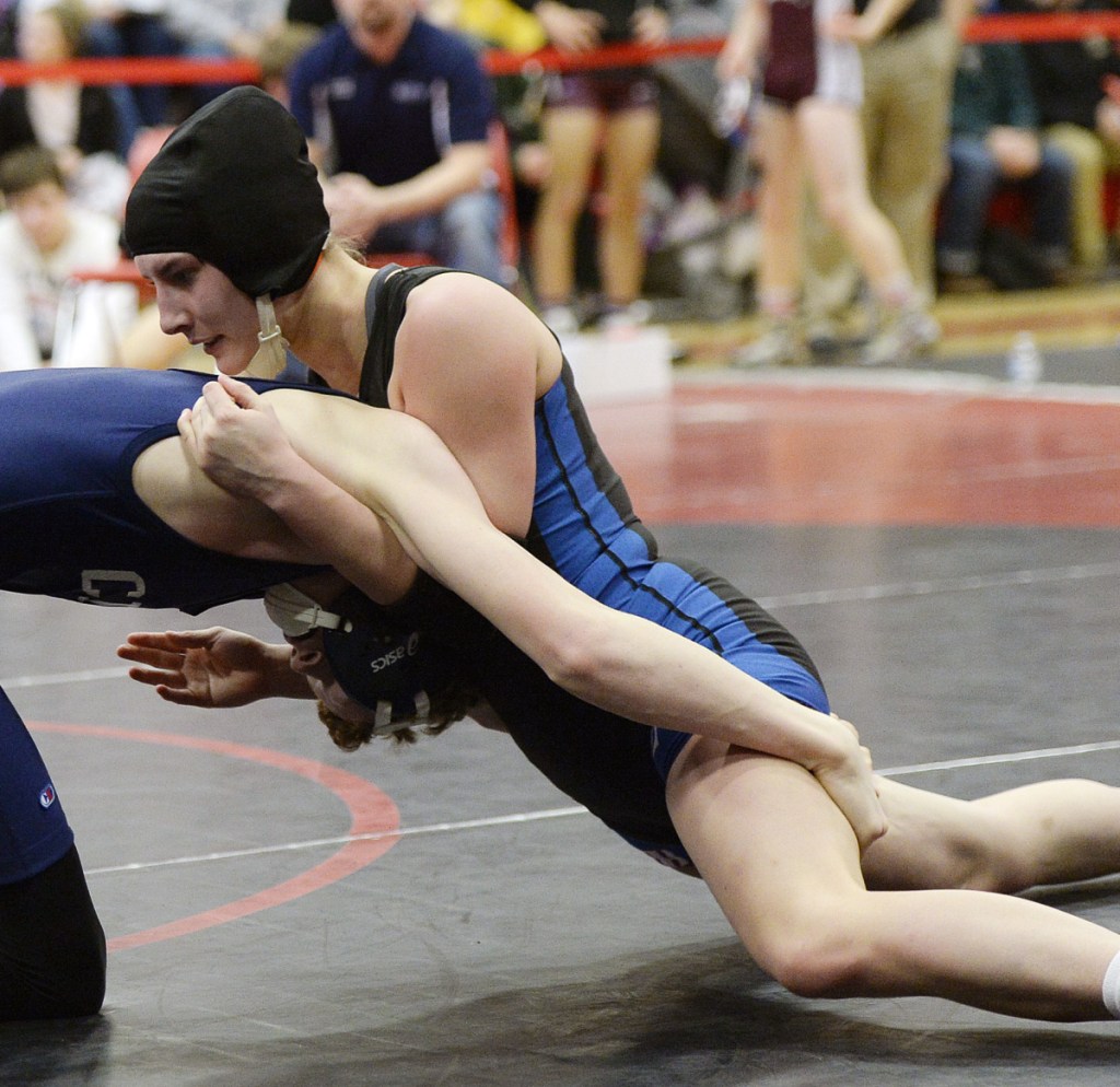 Zoe Buteau, right, qualified three times for the Class B wrestling state championships and finished fourth at 132 pounds this season.