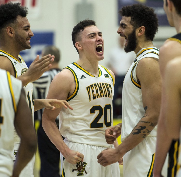 Vermont's Ernie Duncan, center, celebrates with teammates during the championship game of the America East tournament Saturday. The Catamounts beat UMBC 66-49 and earned a berth in the NCAA Tournament.