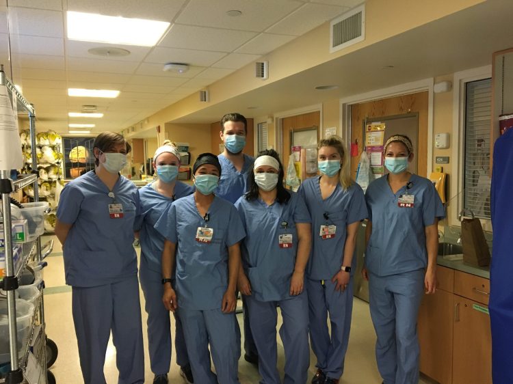 Maine Medical Center nursing team members from a unit where COVID-19 patients have been treated pose for a moment.