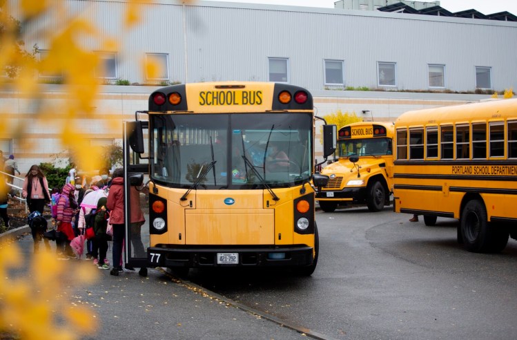 Students get onto buses at Portland's East End Community School at the end of the school day Monday. Portland school officials are preparing for the possibility of bus run cancellations because of an ongoing shortage of drivers. 