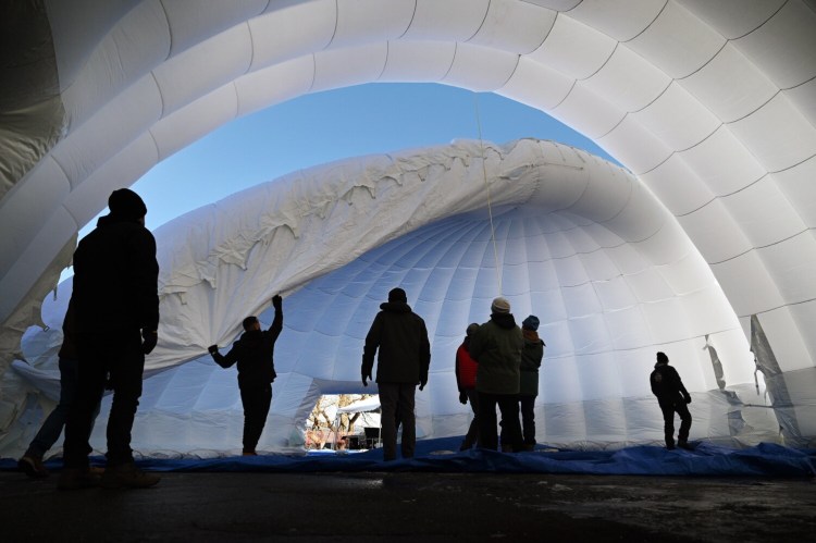 Workers set up the igloo in preparation for the first Carnaval Maine in 2020.