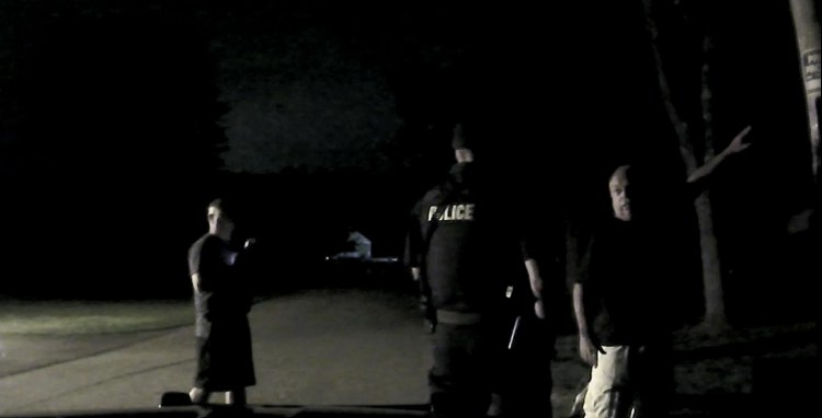 South Berwick Police Chief Dana Lajoie, right, points at a sign that says “Private No Trespassing” during a confrontation with Berwick police on July 20.

